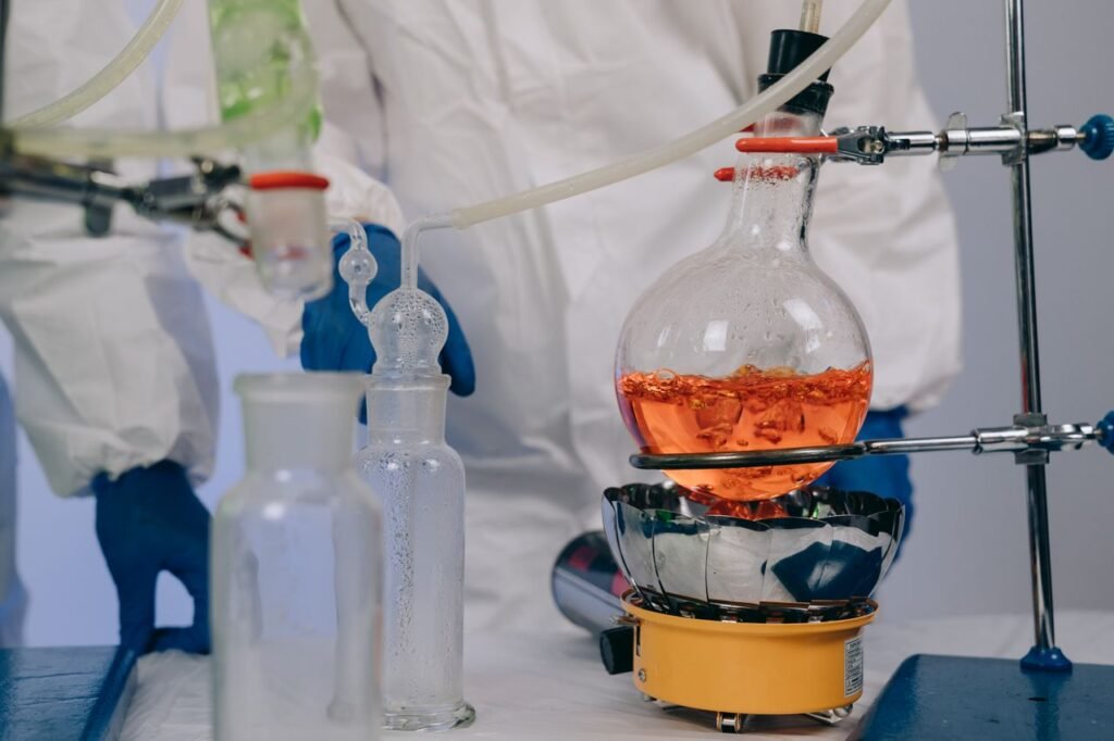 Laboratory scene with scientists conducting a chemical experiment using lab equipment.