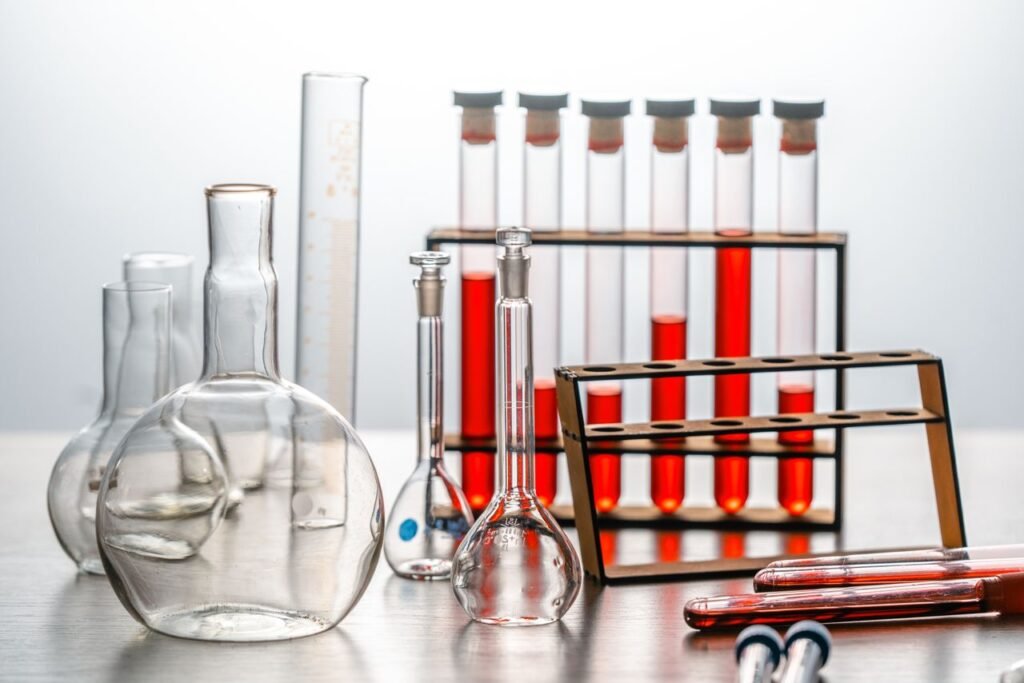 Close-up of various lab glassware with red liquids, ideal for scientific or educational use.